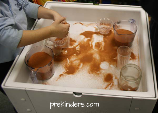 Pouring Sand in the Sensory Table