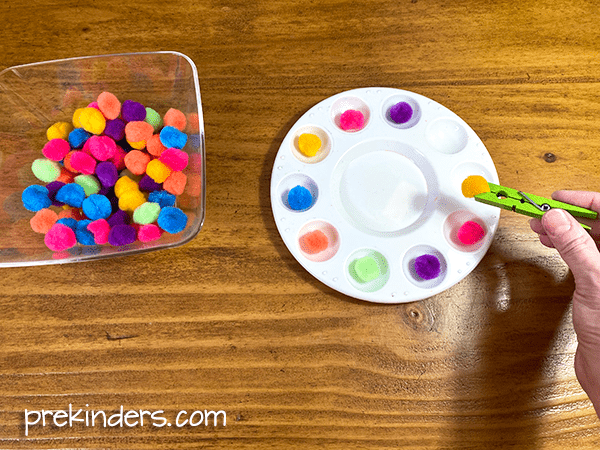 pom poms with clothespins and paint tray