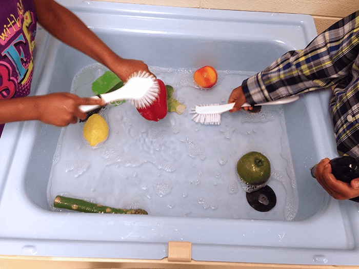 veggie scrubbing sensory table play