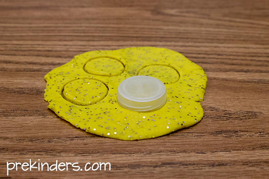 yellow glitter play dough; cut circles with a bottle cap