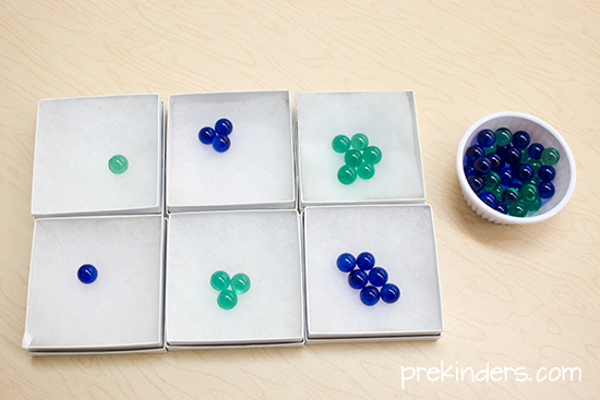 Marbles in gift boxes to teach Pre-K measuring by weight