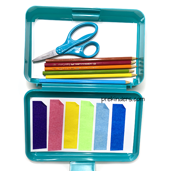 Mini art supply box with colored tape, colored pencils, scissors.
