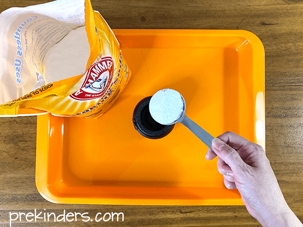 Halloween Science Experiment: add baking soda to the cauldron