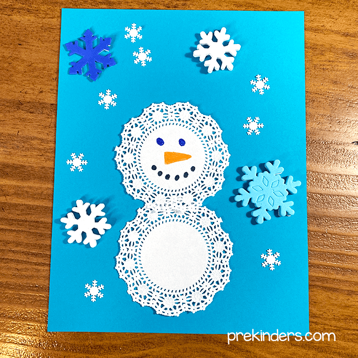 Art with snowman doilies, sequins, foamy stickers